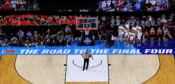 Image: An official waits for play to resume during the second round of the NCAA Men's Basketball Tournament at PNC Arena
