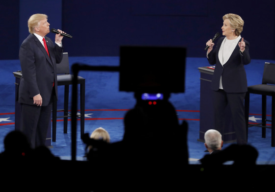 Image: Republican U.S. presidential nominee Donald Trump and Democratic U.S. presidential nominee Hillary Clinton speak during their presidential town hall debate at Washington University in St. Louis