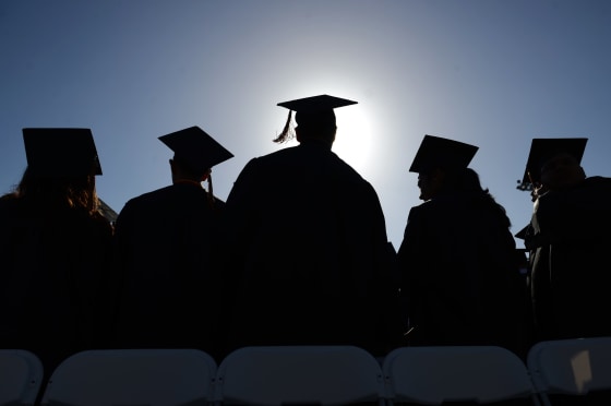 Segerstrom High School graduates stand and sing the school song before they're dismissed from graduation Wednesday June 18, 2014
