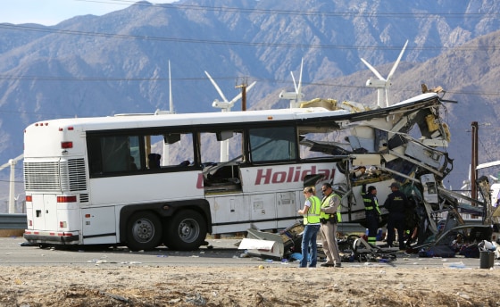 Image: Investigators confer at the scene of a mass casualty bus crash on the westbound Interstate 10 freeway near Palm Springs, California