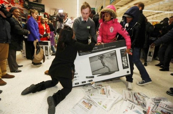 Shoppers wrestle over a television as they compete to purchase retail items on \"Black Friday\" at an Asda superstore in Wembley