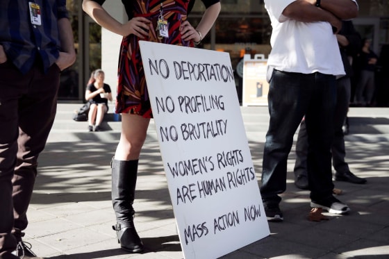 Image: Alice Bynum stands with other Berkeley High School staff members and holds a sign while attending a protest about the election of Republican Donald Trump as President of the United States in Berkeley, California