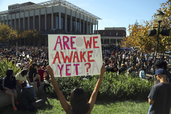 Image: Cristina Levert protests the election of Donald Trump with a mixed group of students from Berkeley High School and University of California, Berkeley, at Sproul Plaza on the university's campus in Berkeley, Calif.