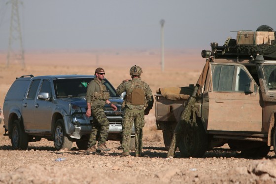 Image: U.S. fighters stand near military vehicles, north of Raqqa city