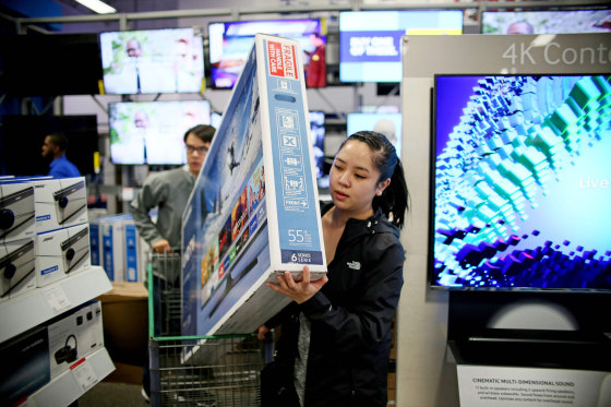 Image: Shoppers buy electronic items during Black Friday sales