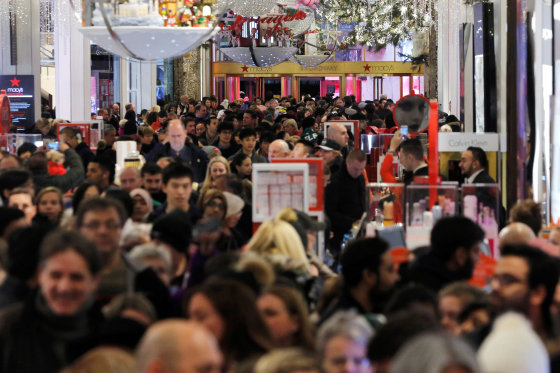 Image: People walk through Macy's Herald Square store during early opening for Black Friday sales in Manhattan, New York