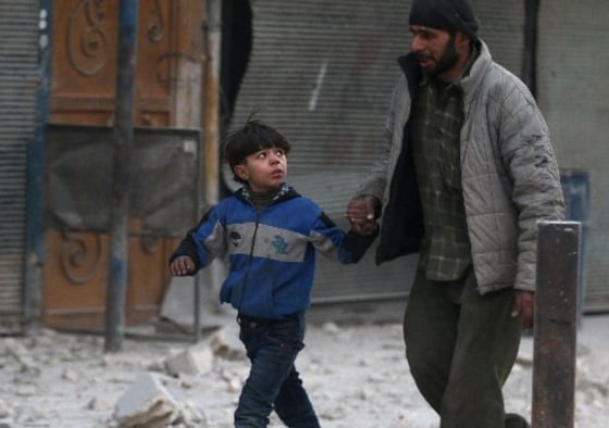 Image: A man holds the hand of a boy