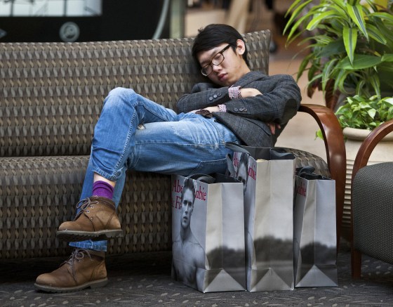 A man sleeps on a couch after shopping at Abercrombie & Fitch at South Park mall in Charlotte