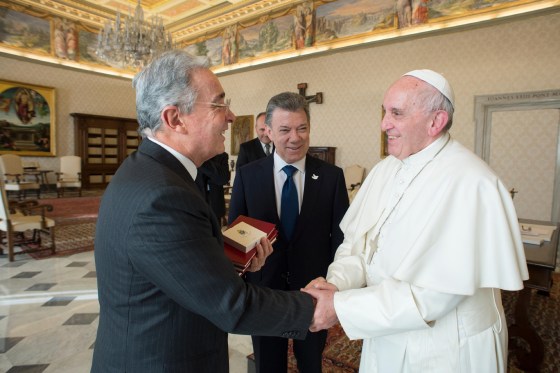 This handout picture released by the Vatican press office shows Colombian president Juan Manuel Santos (C) standing as former president Alvaro Uribe shakes hands with the Pope Francis (R) during a meeting, on January 16, 2016 at the Vatican. -/AFP/Getty