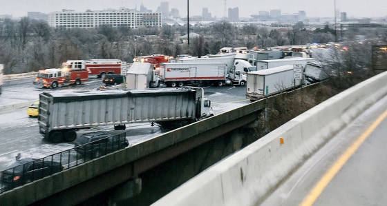 Image: Trucks and vehicles are shown in a pile-up involving a fuel tanker which skidded off the an icey 1-95 highway in Baltimore