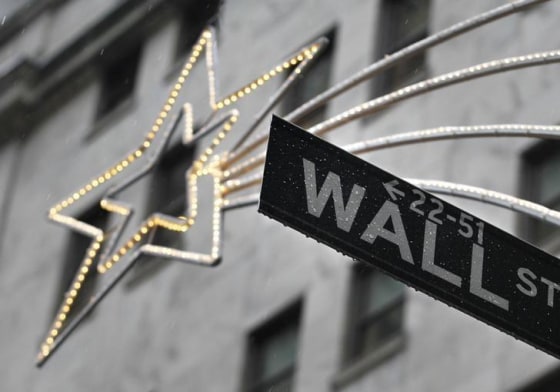 A holiday decoration is seen over Wall St. sign outside the New York Stock Exchange