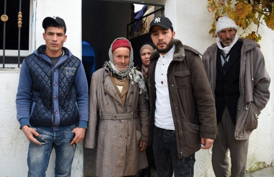 Image: Terror suspect Anis Amri's father Mustapha (second left), brother Walid (L), Hanan (C), and in front the family house in Oueslatia, Tunisia.