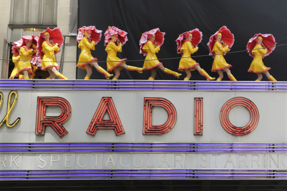 In this June 7, 2016, file photo, dancers from the Radio City Rockettes promote their "New York Spectacular" show by performing on the marquee of Radio City Music Hall in New York. The Radio City Rockettes have been signed on to dance at President-elect Donald Trump?s inauguration next month.