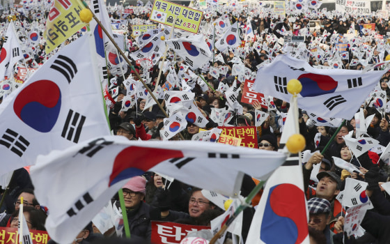 Image: Amid rallies demanding the president's removal, her supporters waved national flags.