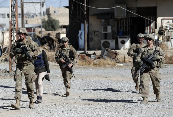 Image: U.S. soldiers patrol near an Iraqi army base