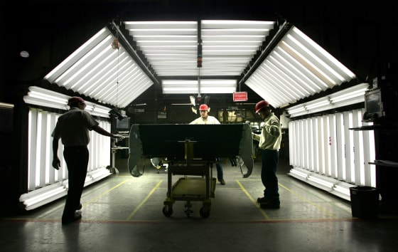 Image: A group of workers at the Toyota Motor Manufacturing de Baja California on Dec. 13, 2004.