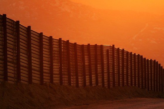 Image: Dusk falls over a section of the U.S.-Mexico border fence on Oct. 8, 2006 near Campo, California.