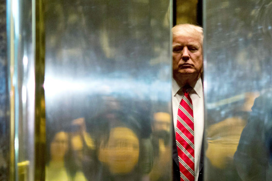 Image: US President-elect Donald Trump boards the elevator after escorting Martin Luther King III