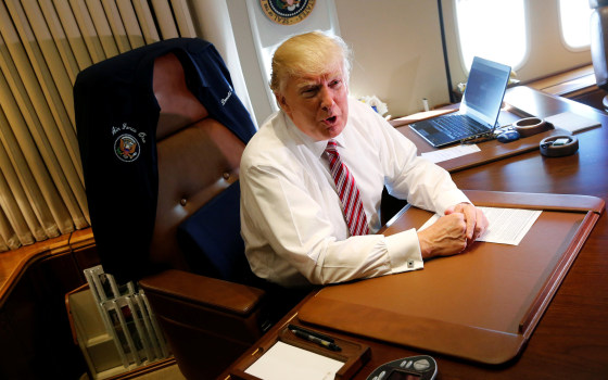 Image: Trump speaks briefly to reporters as he arrives aboard Air Force One at Joint Base Andrews