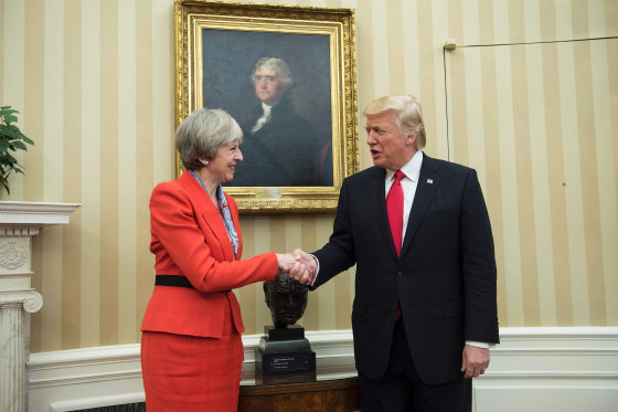 Image: British Prime Minister Theresa May (L) and US President Donald Trump meet beside a bust of former British Prime Minister Winston Churchill in the Oval Offic