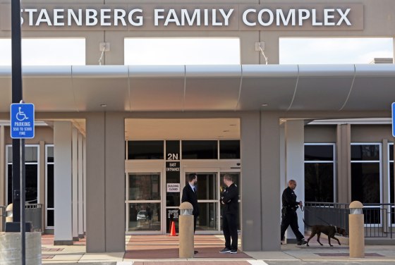 Image: Adults and children return to St. Louis Jewish Community Center on Jan. 18 in St. Louis, Missouri after canine units cleared the building.