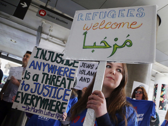 A woman holds a sign saying "welcome" in English and Arabic as demonstrators opposed to President Donald Trump's executive orders barring entry to the U.S. by Muslims from certain countries protest at the Tom Bradley International Terminal at Los Angeles International Airport on Saturday, Feb. 4, 2017.