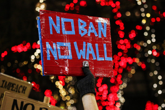 Image: A man holds a sign during a protest held in response to President Trump's travel ban in Seattle, Washington on Jan. 29.