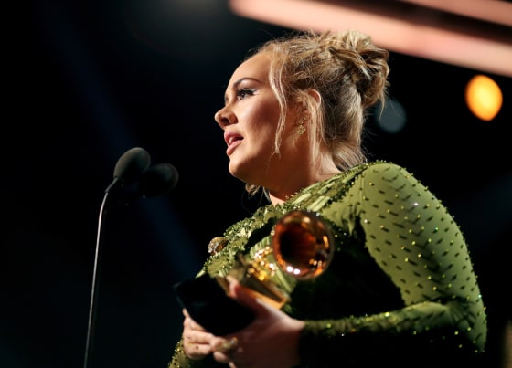 Image: Singer Adele accepts the award for song of the year