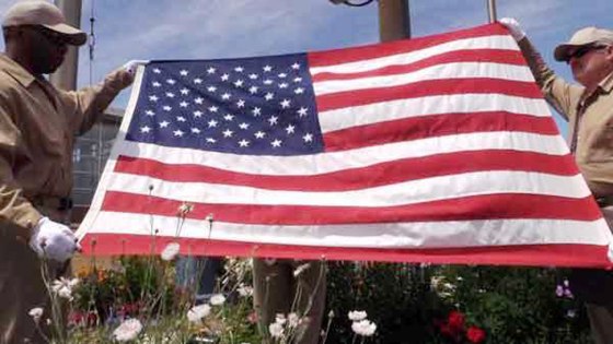 Image: Incarcerated veterans prepare the Stars and Stripes for the morning flag-raising at the Stafford Creek Corrections Center in Washington state.