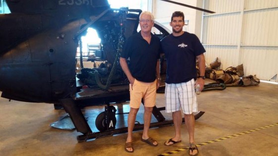 William Owens stands with his son, William "Ryan" Owens, in front of a helicopter in a family photo.