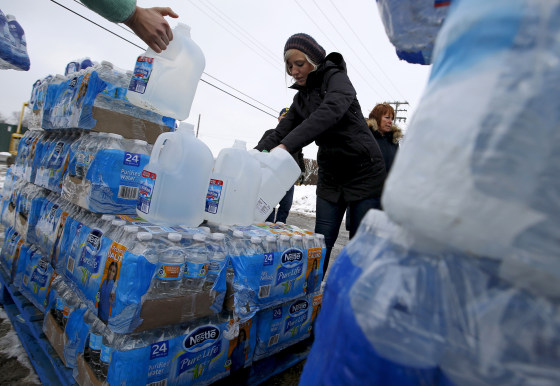 Volunteers distribute bottled water to help combat the effects of the crisis when the city's drinking water became contaminated with dangerously high levels of lead in Flint
