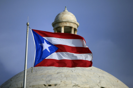 FILE - In this July 29, 2015 file photo, the Puerto Rican flag flies in front of Puerto Rico's Capitol as in San Juan, Puerto Rico.