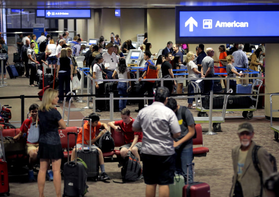 In this May 27, 2016 file photo, passengers line up to check in before their flight at Sky Harbor International Airport in Phoenix.