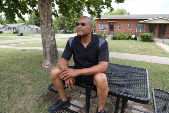 Image: Thomas Webb sits at a table he uses as a meditation area outside his home in Oklahoma City