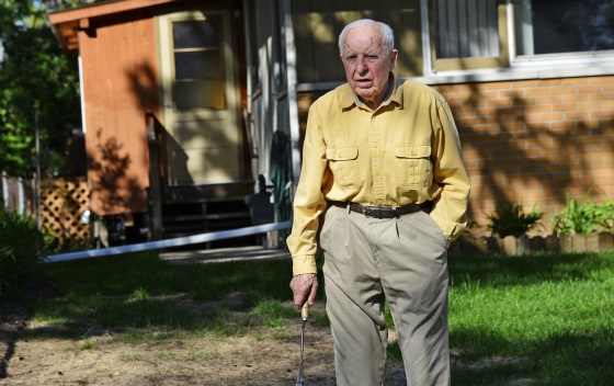 Image: In this May 2014 photo, Michael Karkoc works in his yard in Minneapolis.