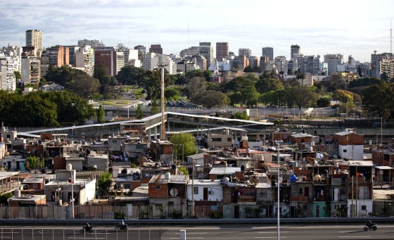 This Oct. 4, 2016 photo shows the Villa 31 neighborhood, backdropped by downtown, as well as middle class apartments and office buildings in Buenos Aires, Argentina.