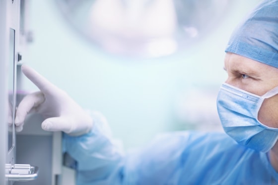 Surgeon touching monitor screen in operating room