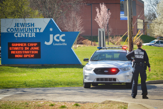 Image: A police officer blocks an entrance as officials respond to a bomb threat at the Jewish Community Center in Louisville