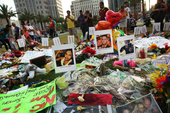 People visit a memorial in Orlando, Florida, for those killed at the Pulse nightclub.