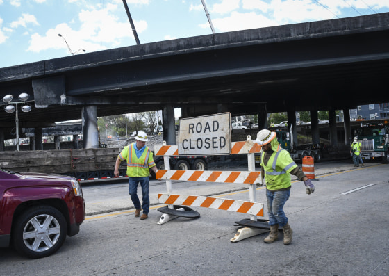 Image: Workers close off a street going under I-85 interstate