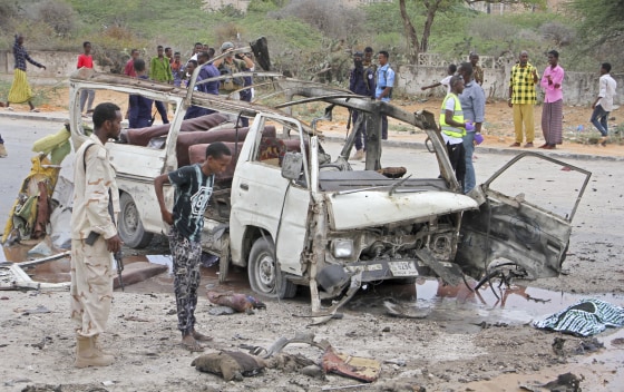Image: A Somali soldier stands by the wreckage of a passing minibus that was destroyed in a suicide car bomb attack near the defense ministry compound in Mogadishu, Somalia, April 9, 2017.