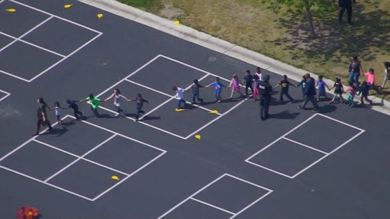 Image: Students are evacuated after a shooting at North Park Elementary School in San Bernardino