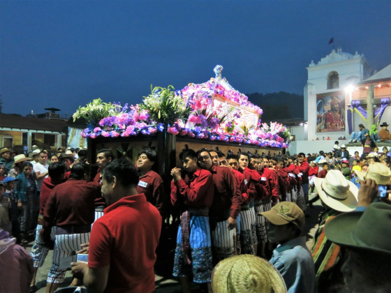 El Señor Sepultado—the statue of the buried Christ— is carried on a wooden platform by the village men in the traditional dress of Santiago Atitlan.