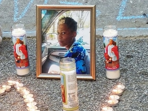Image: Candles burn around a photo of Malachi Hemphill