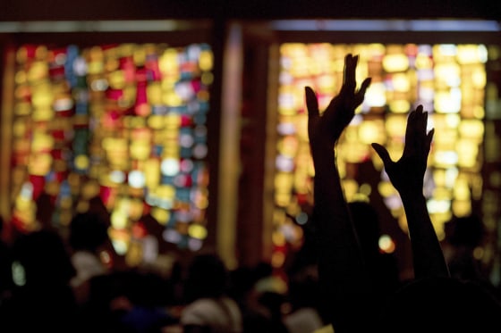 Image: Worshipers puts their hands up before Hillary Clinton takes the stage at New Mount Olive Baptist Church in Fort Lauderdale, Florida, Oct. 30, 2016.