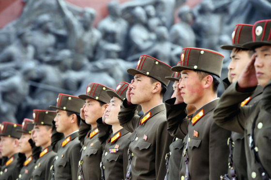 Image: North Korean soldiers salute bronze statues of North Korea's late founder Kim Il-sung and late leader Kim Jong Il at Mansudae in Pyongyang