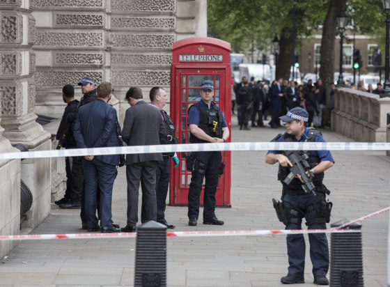 Image: A man is detained by police officers near London's Downing Street.