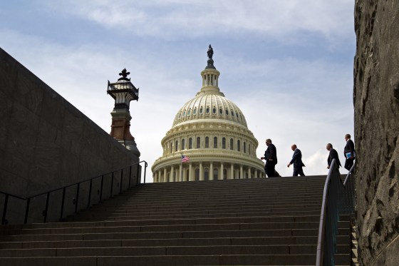 Image: People walk outside of the U.S. Capitol in Washington