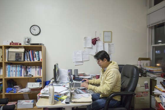 Myong Sool Chang, founder of Boston Korea, works at his desk in the weekly newspaper's Allston office. Chang started the newspaper in 2005, working alone full-time and using his credit card to get by. These days, he works with a staff of five.
