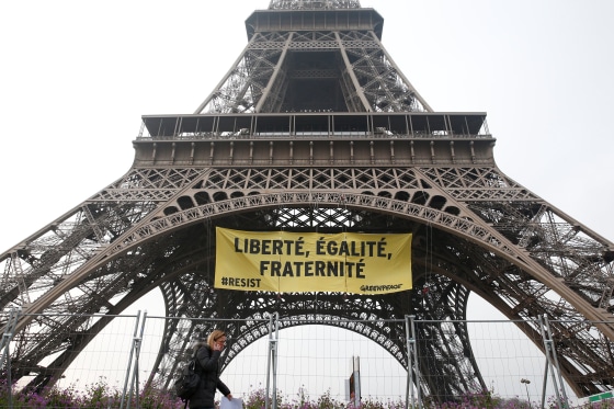 Image: Greenpeace activists unfurl a giant banner on the Eiffel Tower, in Paris.